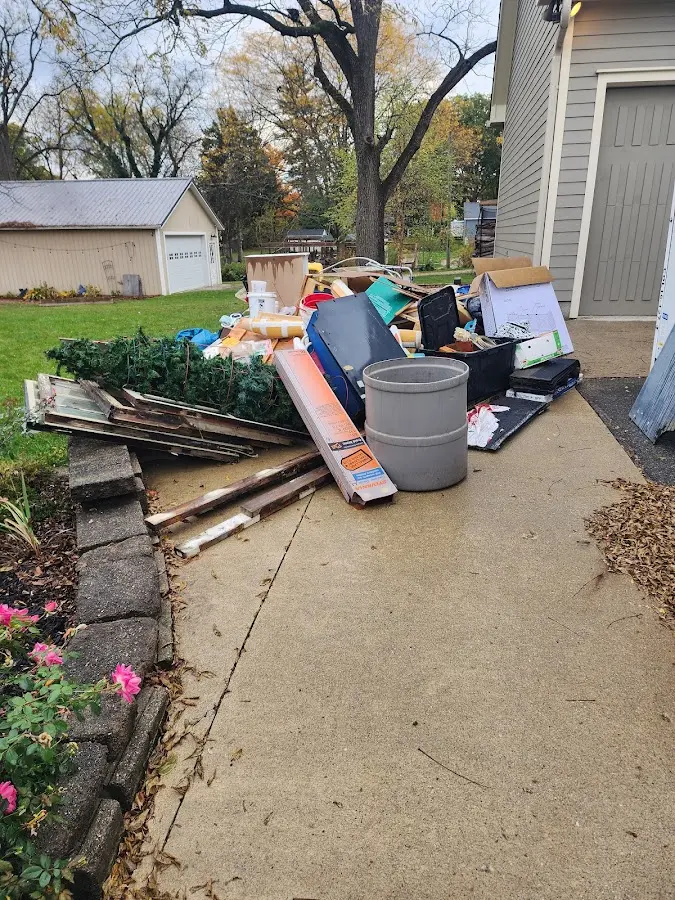 Dumpster being loaded with debris for 10 Yard Dumpster Rental in Whitefish Bay